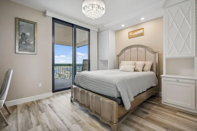 a bathroom with a granite countertop sink a mirror and shower