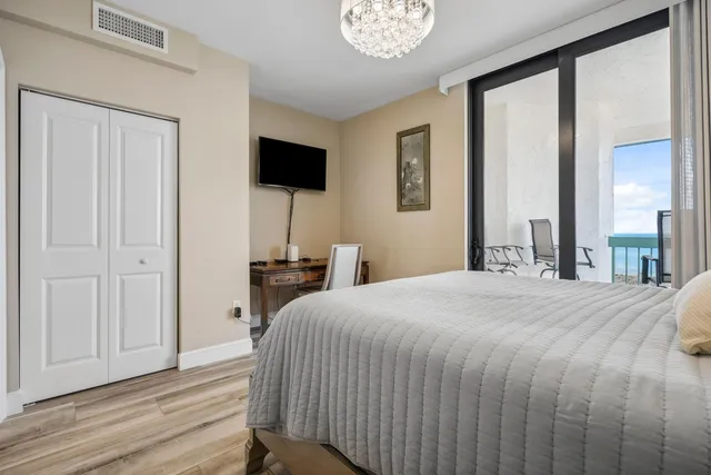 a bedroom with a bed and a chandelier