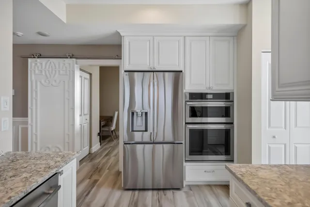 a very nice looking room with a large window and wooden floor