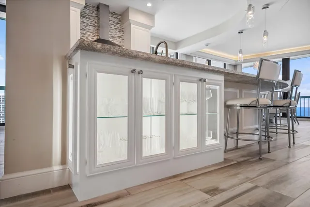 a living room with furniture a flat screen tv and a floor to ceiling window