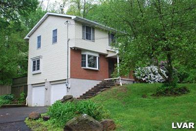 495 Buttermilk Road Hellertown, PA 18055 - Photo 4 of 34 a front view of a house with a garden