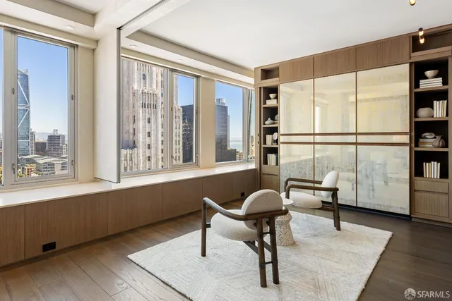 a living room with furniture and large windows