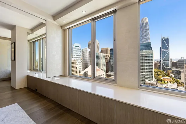 a bedroom with a bed and a window with wall paintings