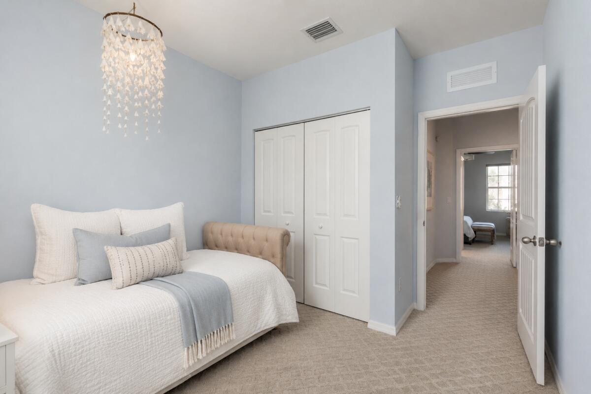 468 Francesca Ridge Road Boynton Beach, FL 33435 - Photo 7 of 11 a bedroom with a bed and a chandelier