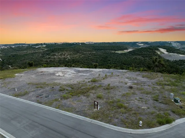 a view of a field with wooden fence