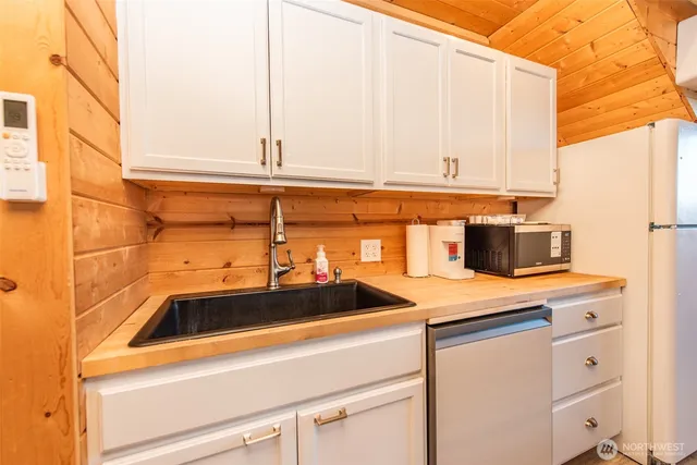 a kitchen with a sink and a stove top oven