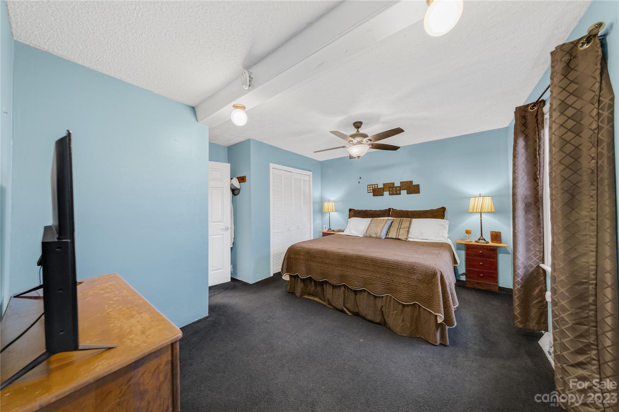 1260 State Rd S-46-536 Rock Hill, SC 29732 - Photo 21 of 34 a spacious bedroom with a bed and a flat tv screen on dresser
