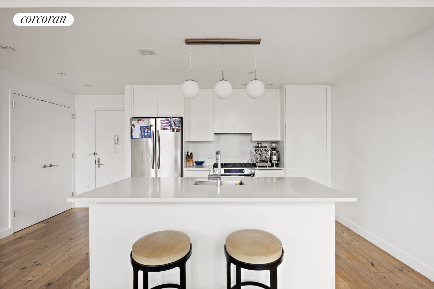 23 West 116th Street, Unit 12D Manhattan, NY 10026 - Photo 3 of 15 a kitchen with kitchen island a stove cabinets and wooden floor