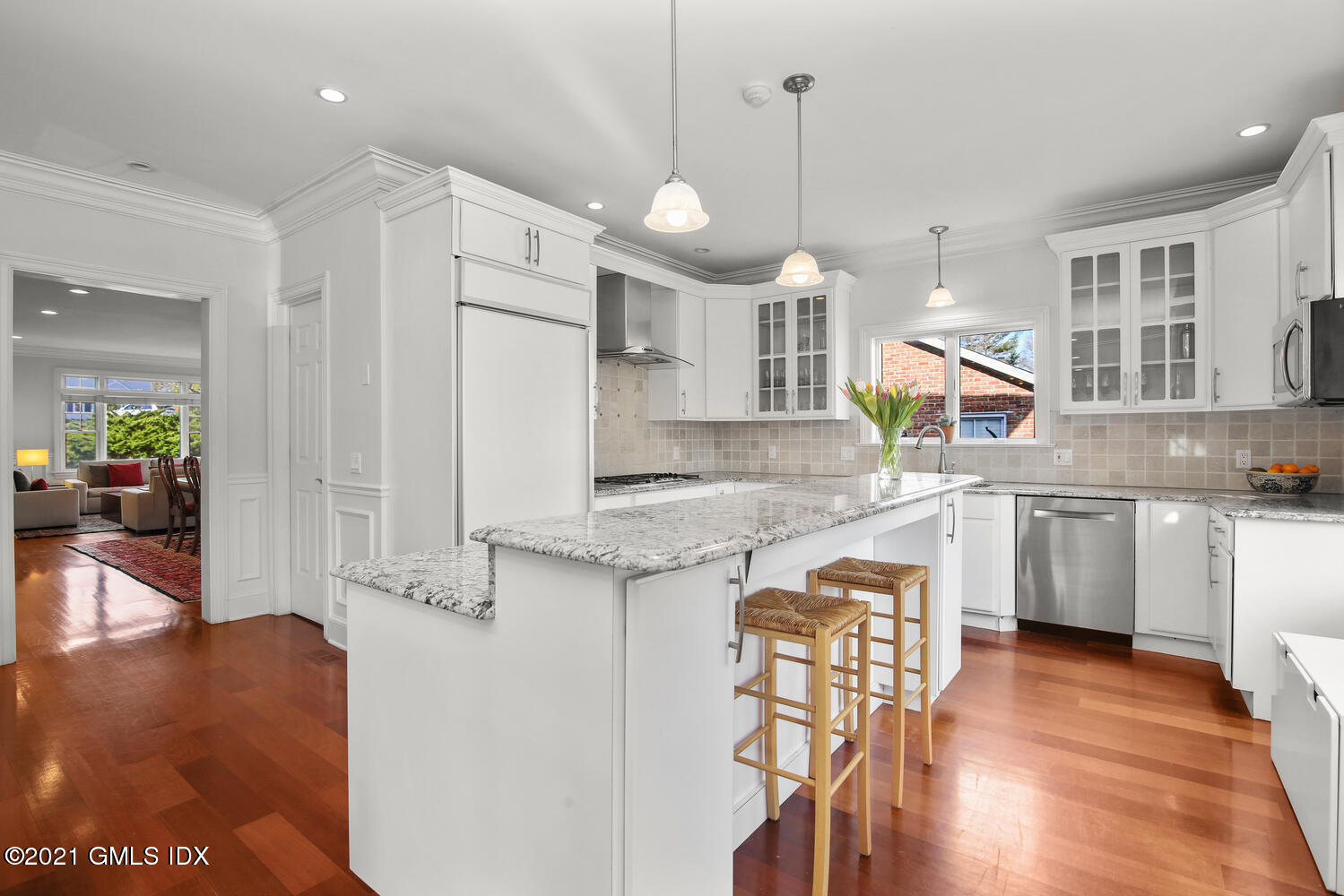 39 Lockwood Lane Riverside, CT 06878 - Photo 18 of 85 a kitchen with stainless steel appliances granite countertop a refrigerator a sink dishwasher a stove and white cabinets with wooden floor