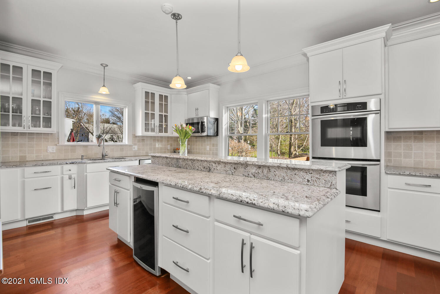 39 Lockwood Lane Riverside, CT 06878 - Photo 19 of 85 a kitchen with stainless steel appliances granite countertop a sink a stove a microwave oven a refrigerator with white cabinets and wooden floor