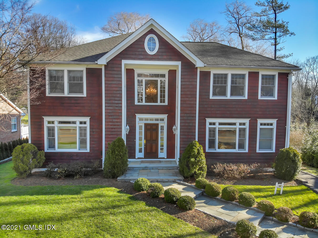 39 Lockwood Lane Riverside, CT 06878 - Photo 81 of 85 a front view of a house with a yard and garage
