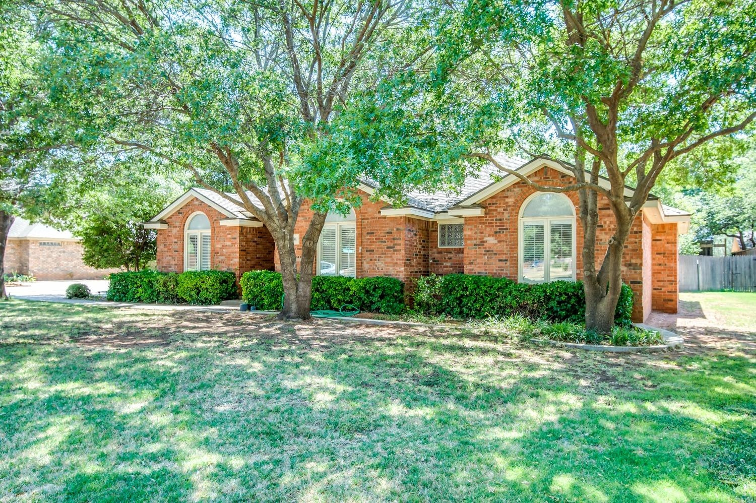 8404 Rochester Avenue Lubbock, TX 79424 - Photo 1 of 10 a front view of a house with a yard and trees