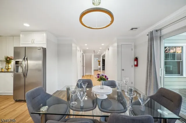 a dining room with furniture a window and kitchen view