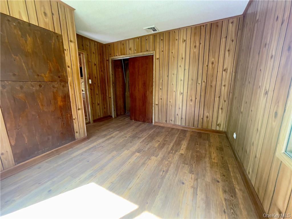 4 Old Turnpike Road Bloomingburg, NY 12721 - Photo 25 of 27 Spare room with wood walls and hardwood / wood-style floors