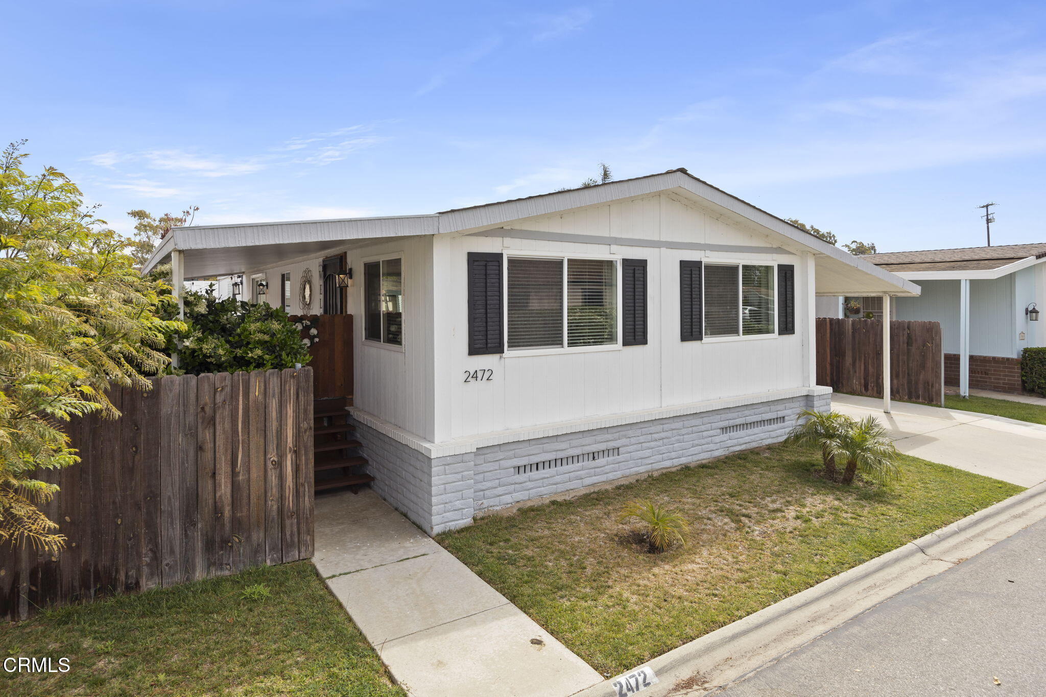 2472 Apple Lane, Unit 170 Oxnard, CA 93036 - Photo 1 of 47 a view of a house with a small yard and wooden fence