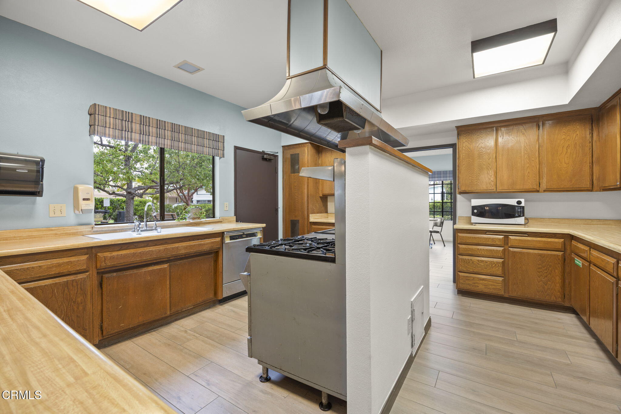 2472 Apple Lane, Unit 170 Oxnard, CA 93036 - Photo 43 of 47 a kitchen with stainless steel appliances granite countertop a refrigerator a sink dishwasher a stove and white countertops with wooden floor