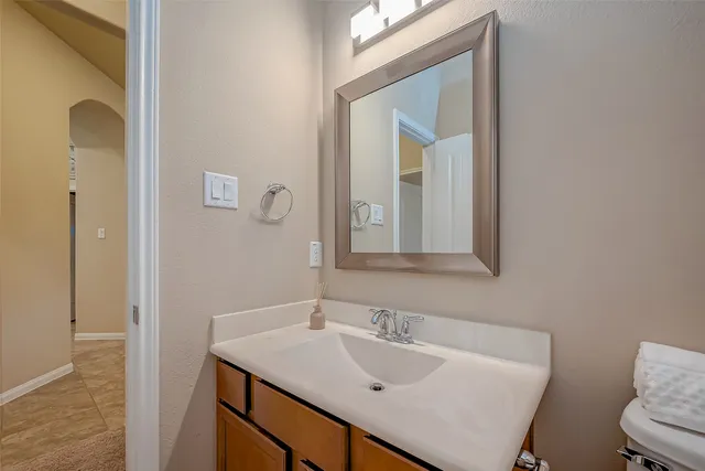 a bathroom with a sink vanity and a mirror