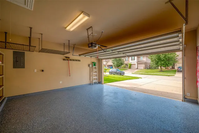 a view of an empty room with a floor to ceiling window and a ceiling fan