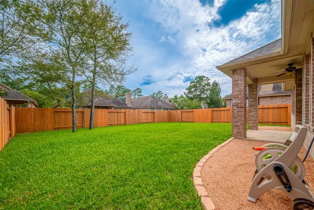 a view of a backyard with a garden and entertaining space