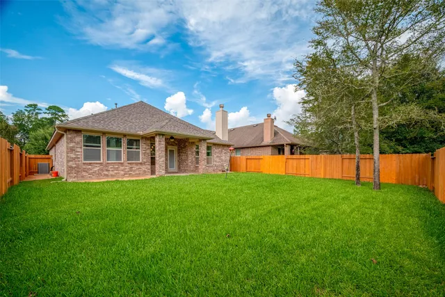 a view of a house with a backyard