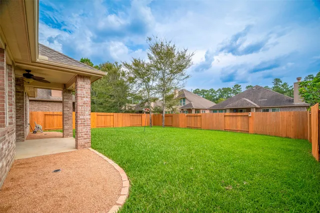 a view of a house with backyard and a garden
