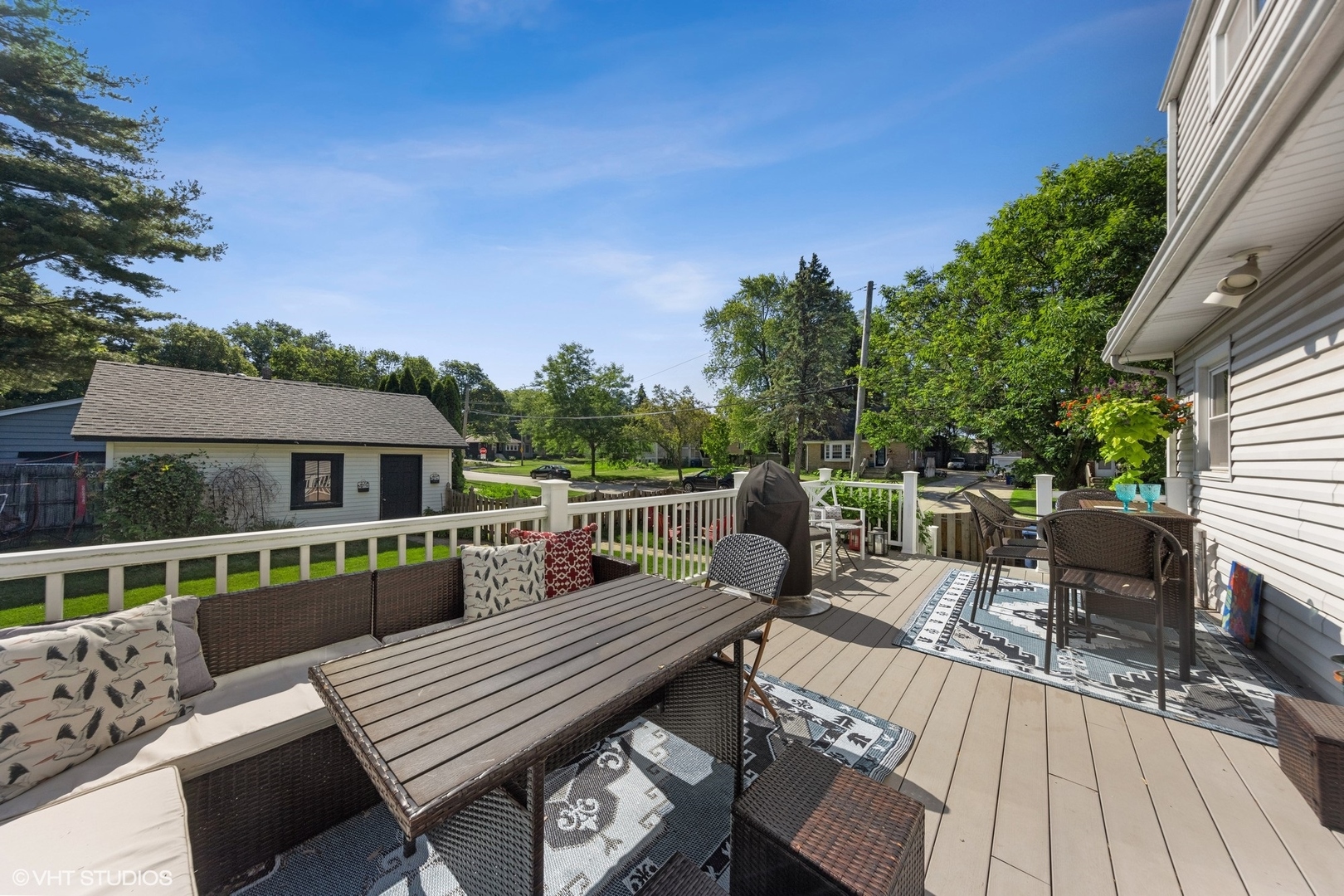 401 Lyon Avenue Wheaton, IL 60187 - Photo 22 of 34 a view of a roof deck with table and chairs with wooden floor and fence