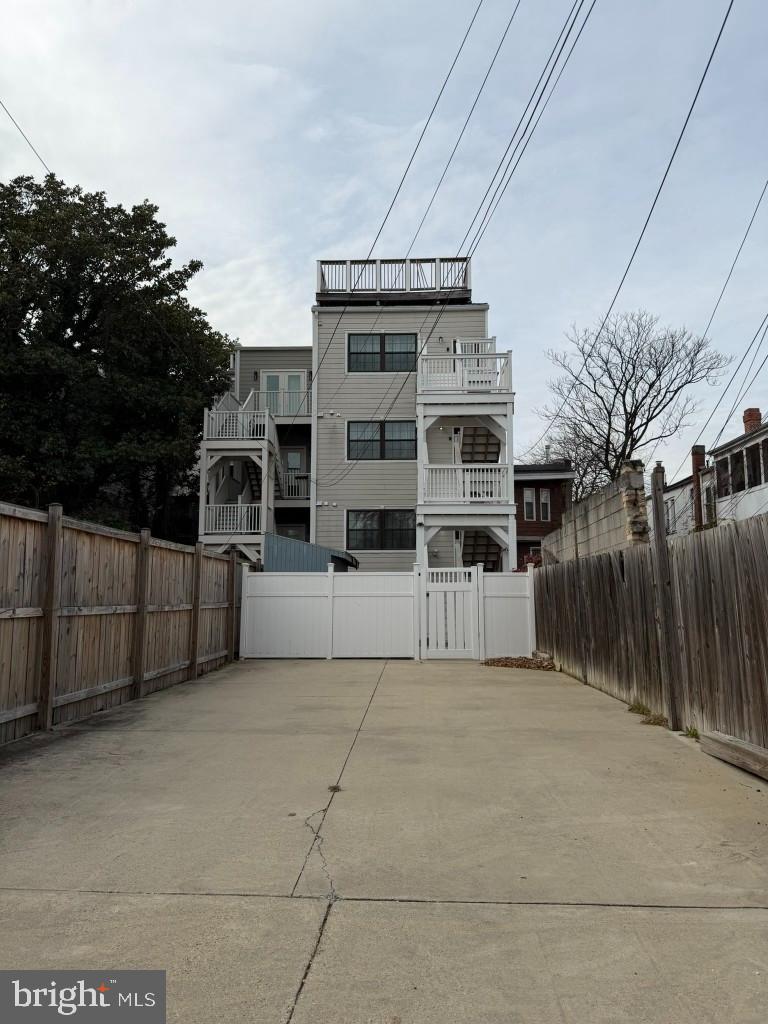 3223 Warder Street Northwest, Unit 2 Washington, DC 20010 - Photo 4 of 5 a view of a house with a big yard and large trees