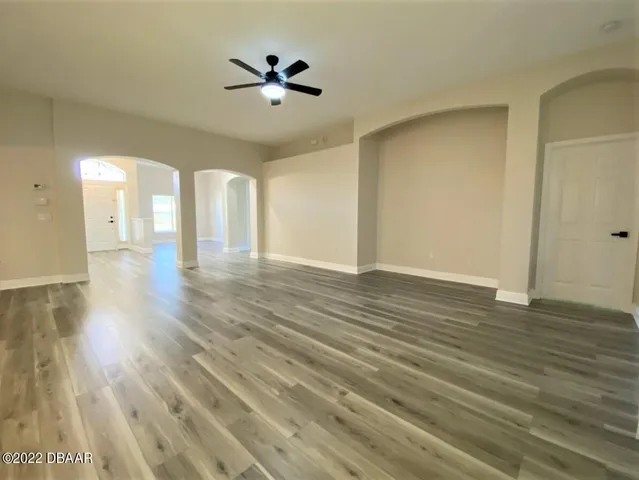 a view of an empty room and wooden floor