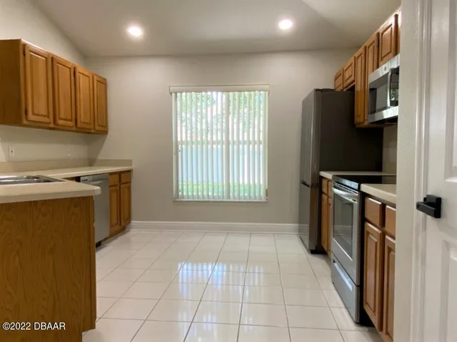 a kitchen with stainless steel appliances a stove a microwave and a refrigerator