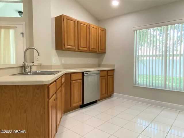 a kitchen with a sink cabinets and window