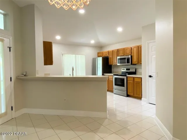a kitchen with stainless steel appliances a refrigerator and a stove top oven