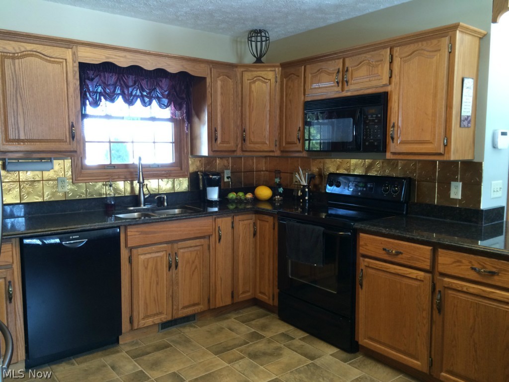 3463 Lester Road Medina, OH 44256 - Photo 8 of 24 Rich solid wood cabinets accented with granite counters and copper tile backsplash. All appliances stay.