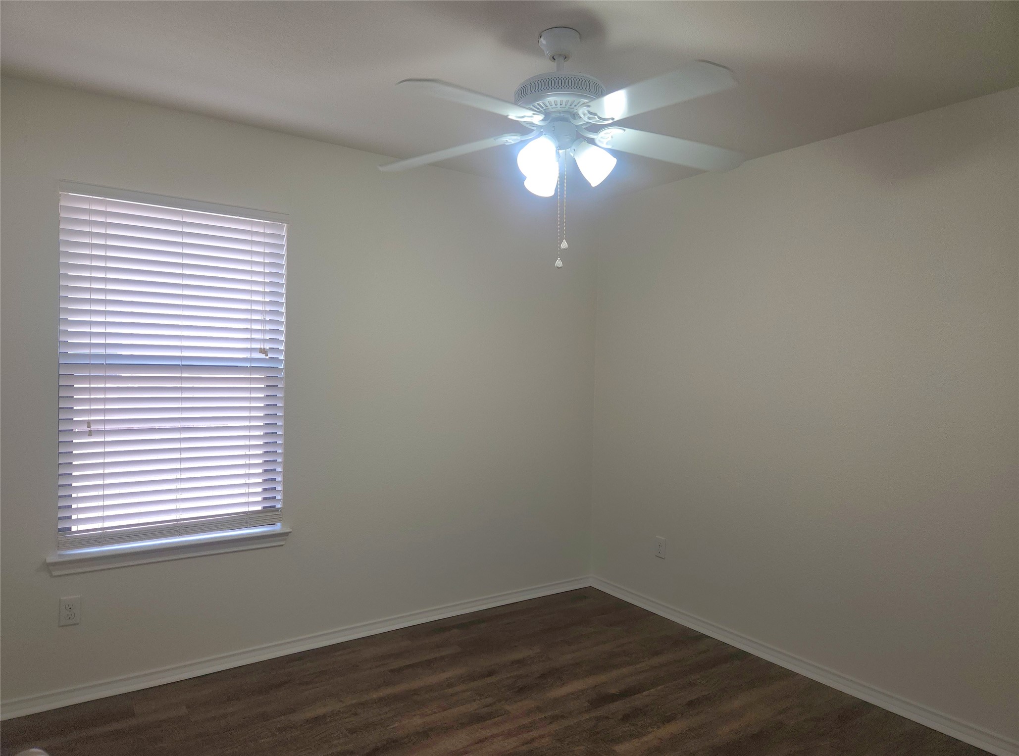 160 Rummel Drive Kyle, TX 78640 - Photo 11 of 13 Well-lit interior space with durable wood-look flooring and a functional ceiling fan.