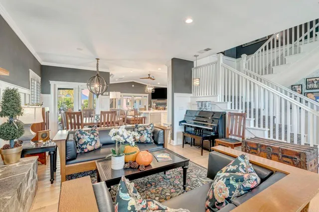 a dining area with furniture a chandelier and kitchen view
