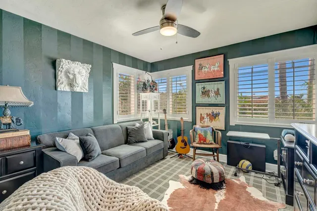 a living room with a bed furniture and a window