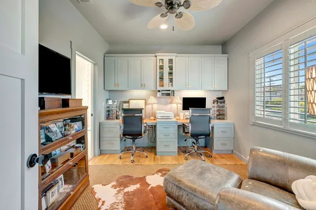 a view of a patio with a table and chairs under an umbrella