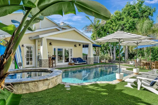 a bedroom with a bed a window and potted plant on the table