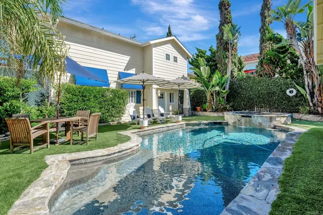 a view of a patio with table and chairs potted plants and a large tree