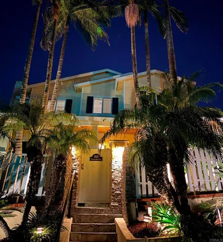 a front view of a house with a garden