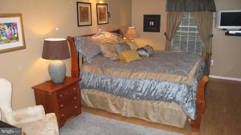 8532 Riverside Road Alexandria, VA 22308 - Photo 11 of 22 a bedroom with a bed and a television