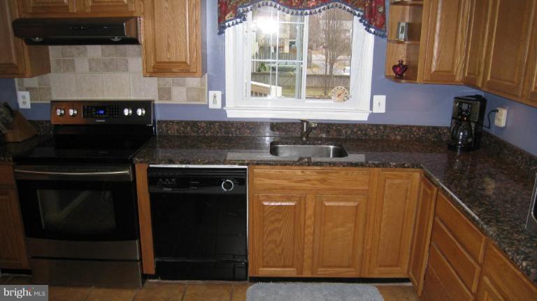 8532 Riverside Road Alexandria, VA 22308 - Photo 21 of 22 a kitchen with granite countertop cabinets stainless steel appliances and a sink