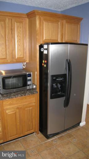 8532 Riverside Road Alexandria, VA 22308 - Photo 22 of 22 a kitchen with stainless steel appliances granite countertop a refrigerator and a microwave