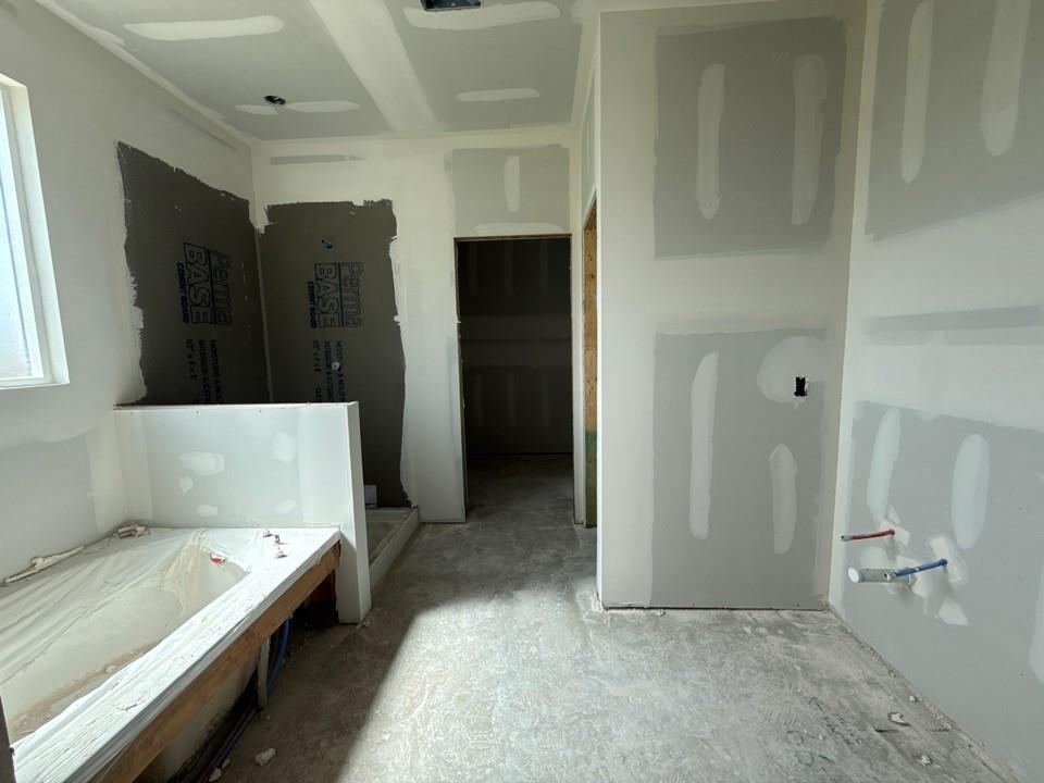 1224 Colca Drive Springtown, TX 76082 - Photo 7 of 8 Bathroom under construction featuring a tub enclosure, shower area with backer board, and drywall-finished walls