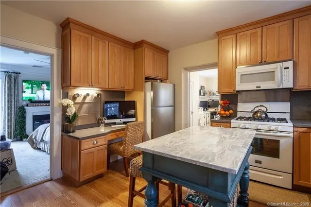 a kitchen with a stove a refrigerator and a stove top oven