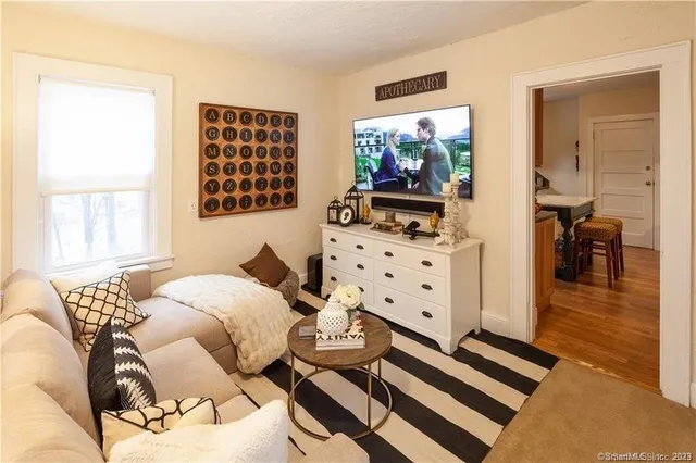 a bedroom with furniture and a flat screen tv