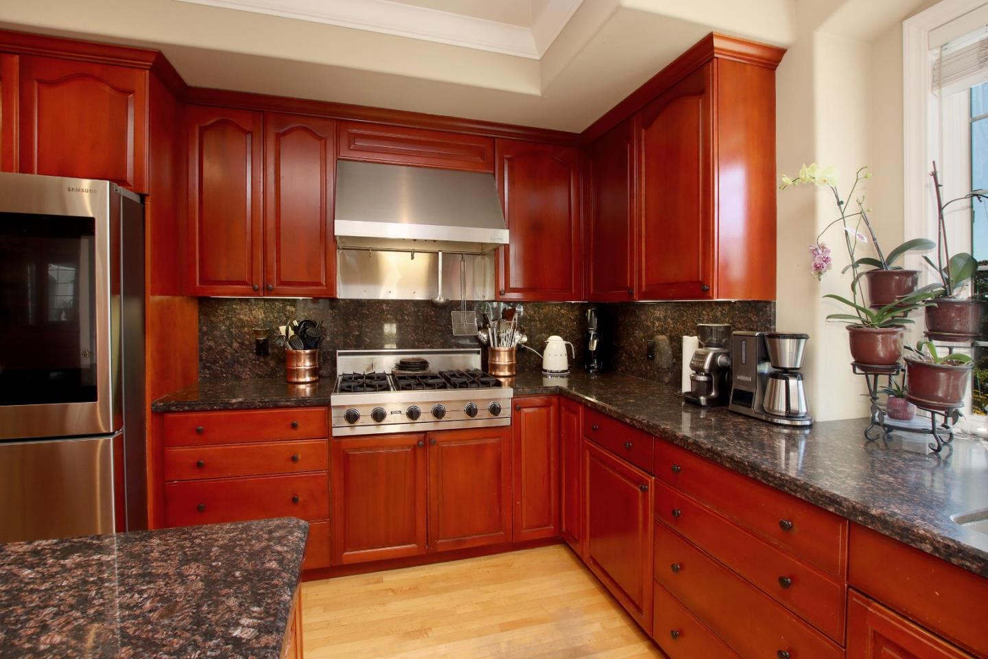 344 Los Robles Road Soquel, CA 95073 - Photo 18 of 76 a kitchen with stainless steel appliances granite countertop wooden cabinets a stove top oven a sink and dishwasher