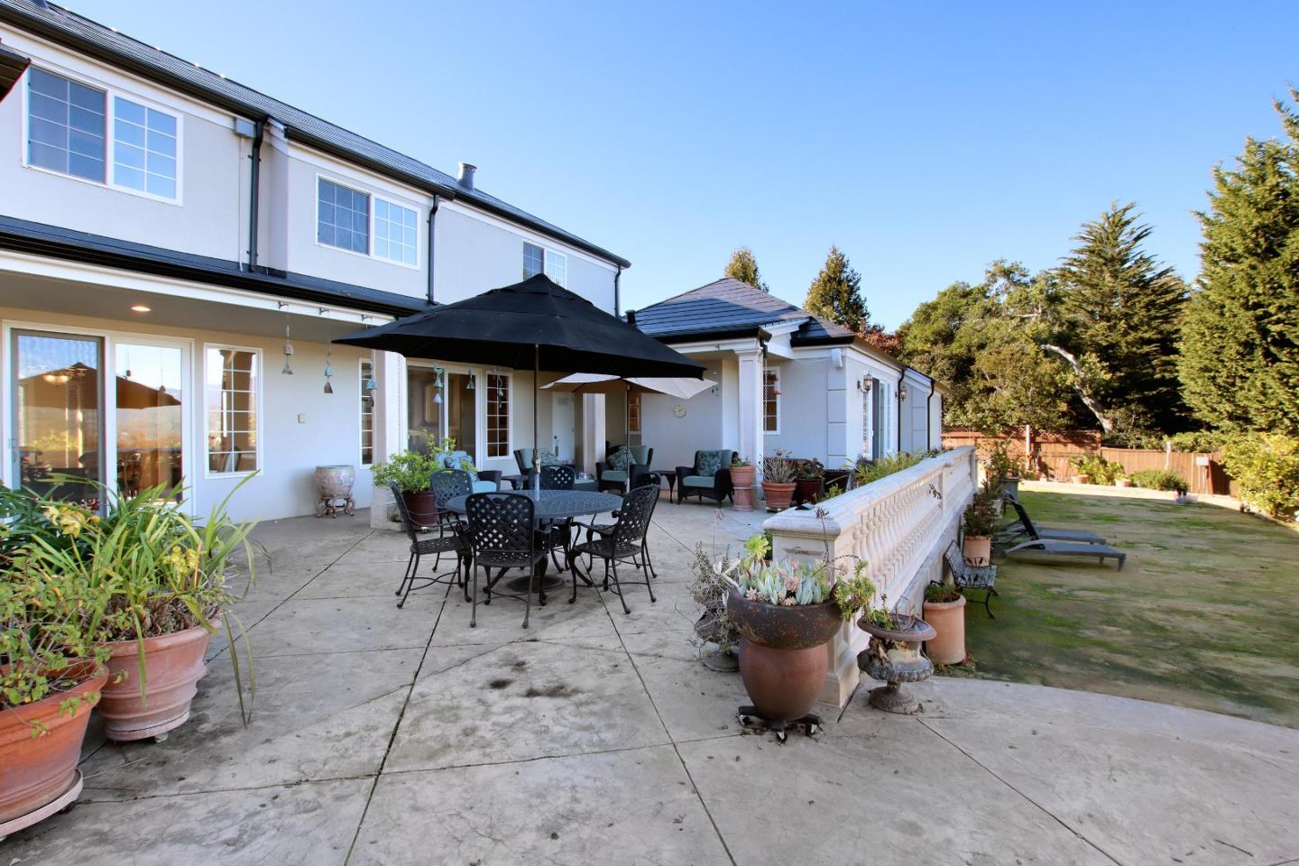 344 Los Robles Road Soquel, CA 95073 - Photo 27 of 76 a view of a patio with table and chairs potted plants and a large tree