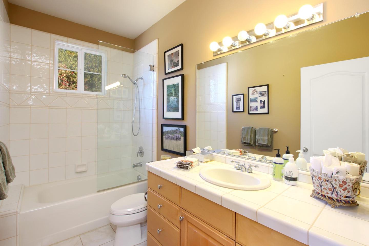 344 Los Robles Road Soquel, CA 95073 - Photo 43 of 76 a bathroom with a granite countertop sink and a mirror