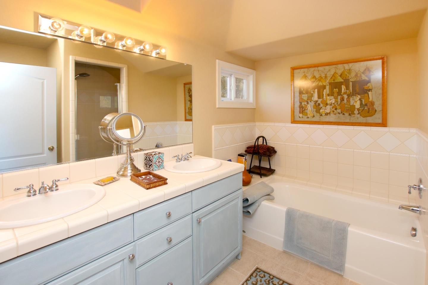 344 Los Robles Road Soquel, CA 95073 - Photo 57 of 76 a bathroom with a tub sink and mirror