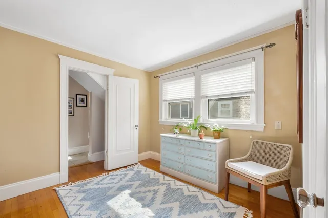 a view of a bedroom with a window and furniture